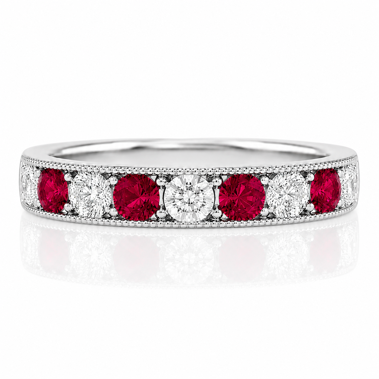 A silver ring with a row of red and white diamonds set in the band.