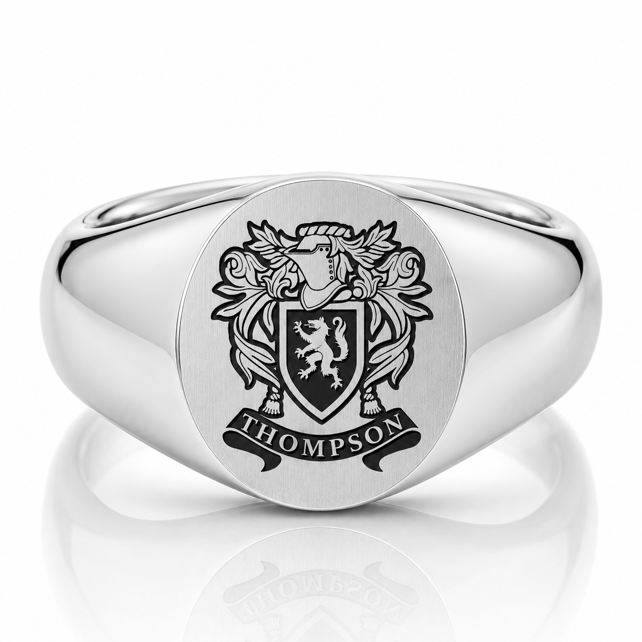 A silver ring with a coat of arms featuring a lion and the word "THOMPSON" below it.