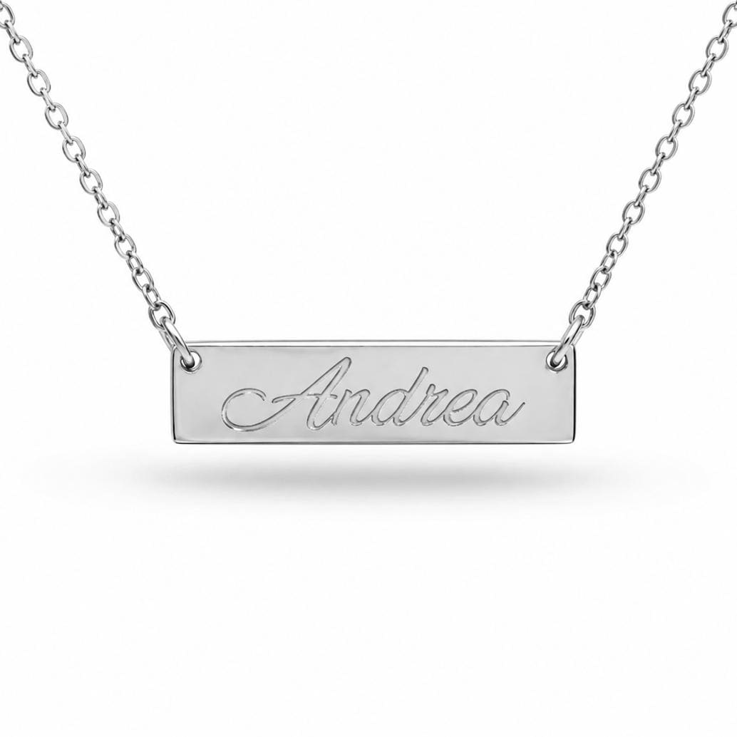 A silver-colored necklace with a rectangular pendant engraved with the name "Andrea".