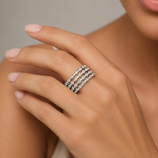 A close-up of a person's hand wearing a ring with multiple small diamonds.