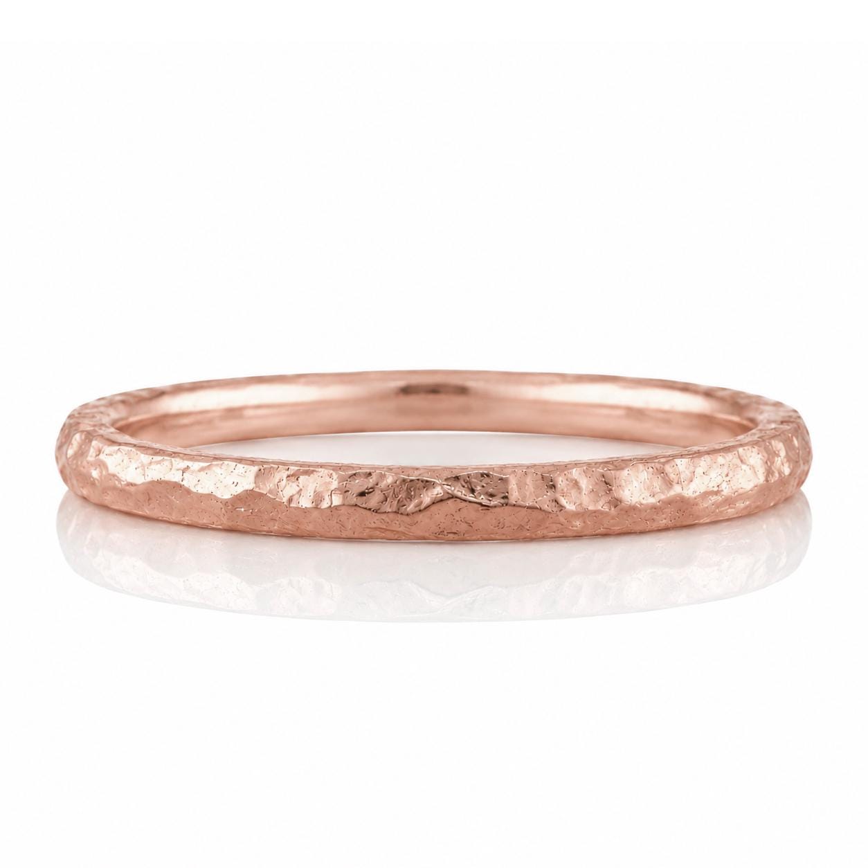 A copper-colored ring with a textured, rough surface.