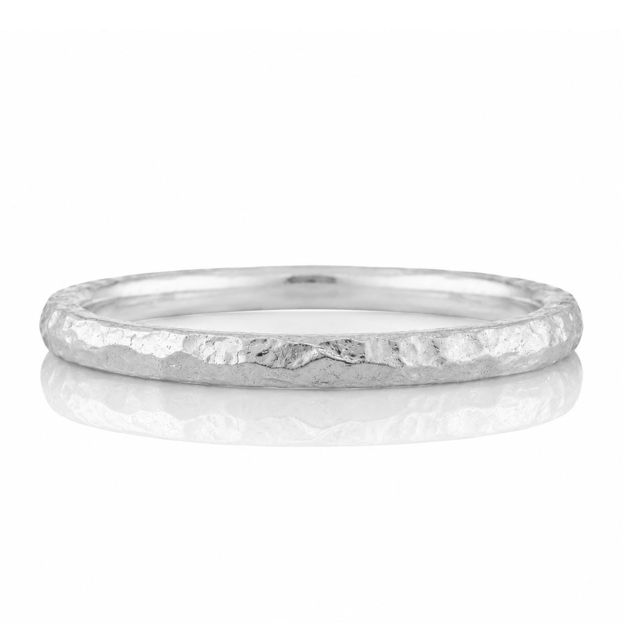A silver ring with a textured surface, reflecting on a white background.