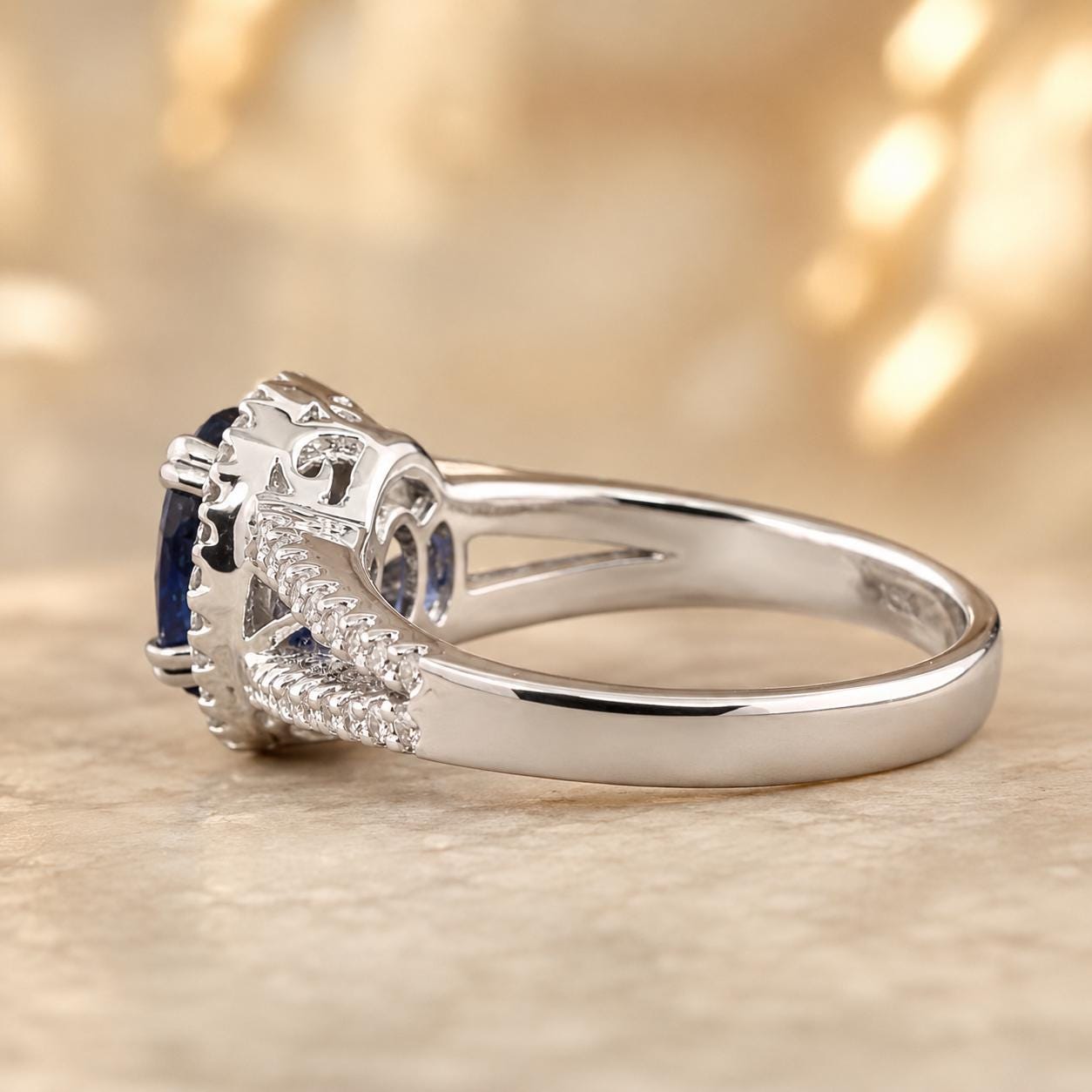 A close-up view of a silver ring with a blue gemstone, showcasing the intricate design and details of the jewelry piece.
