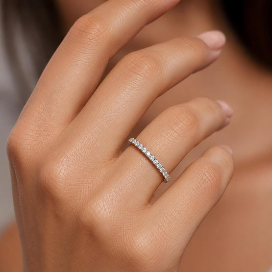 A close-up of a person's hand wearing a diamond-encrusted ring.