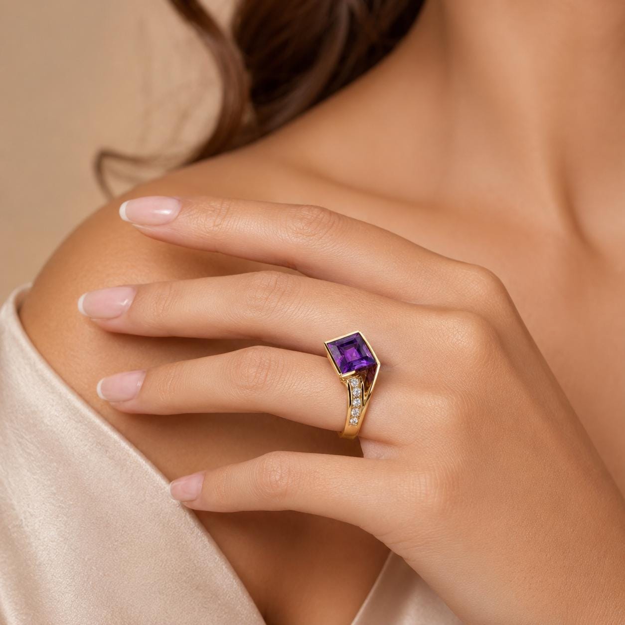 A close-up of a hand wearing a gold ring with a purple gemstone, resting on a shoulder.