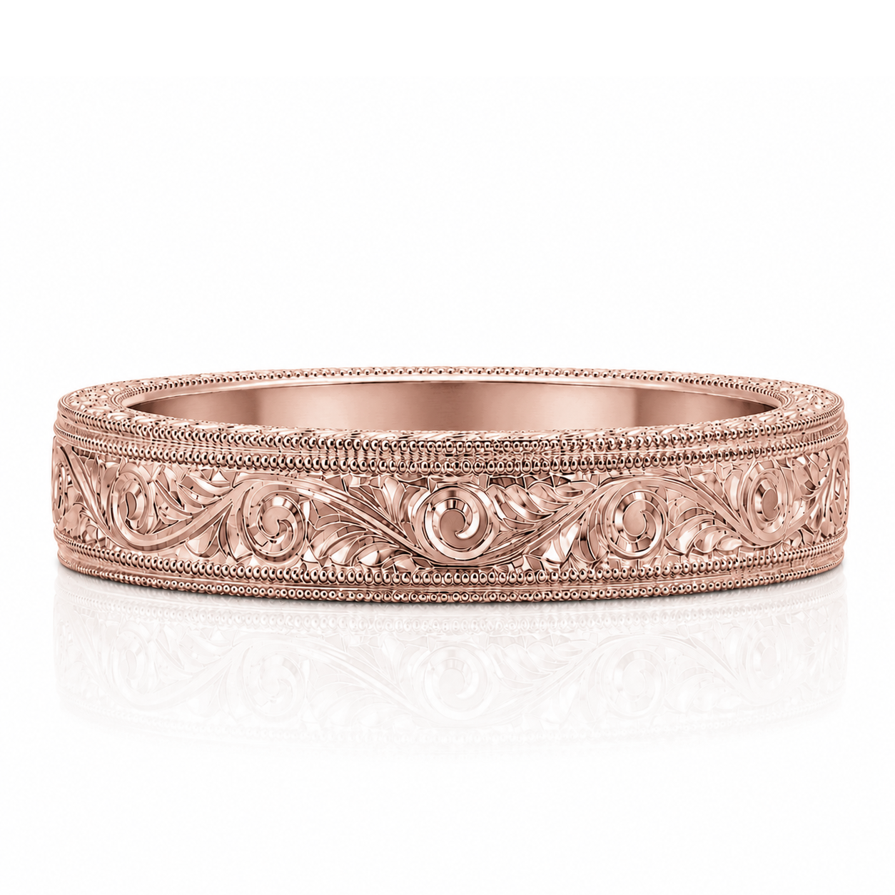 A rose gold band with an intricate engraved design along the top edge.