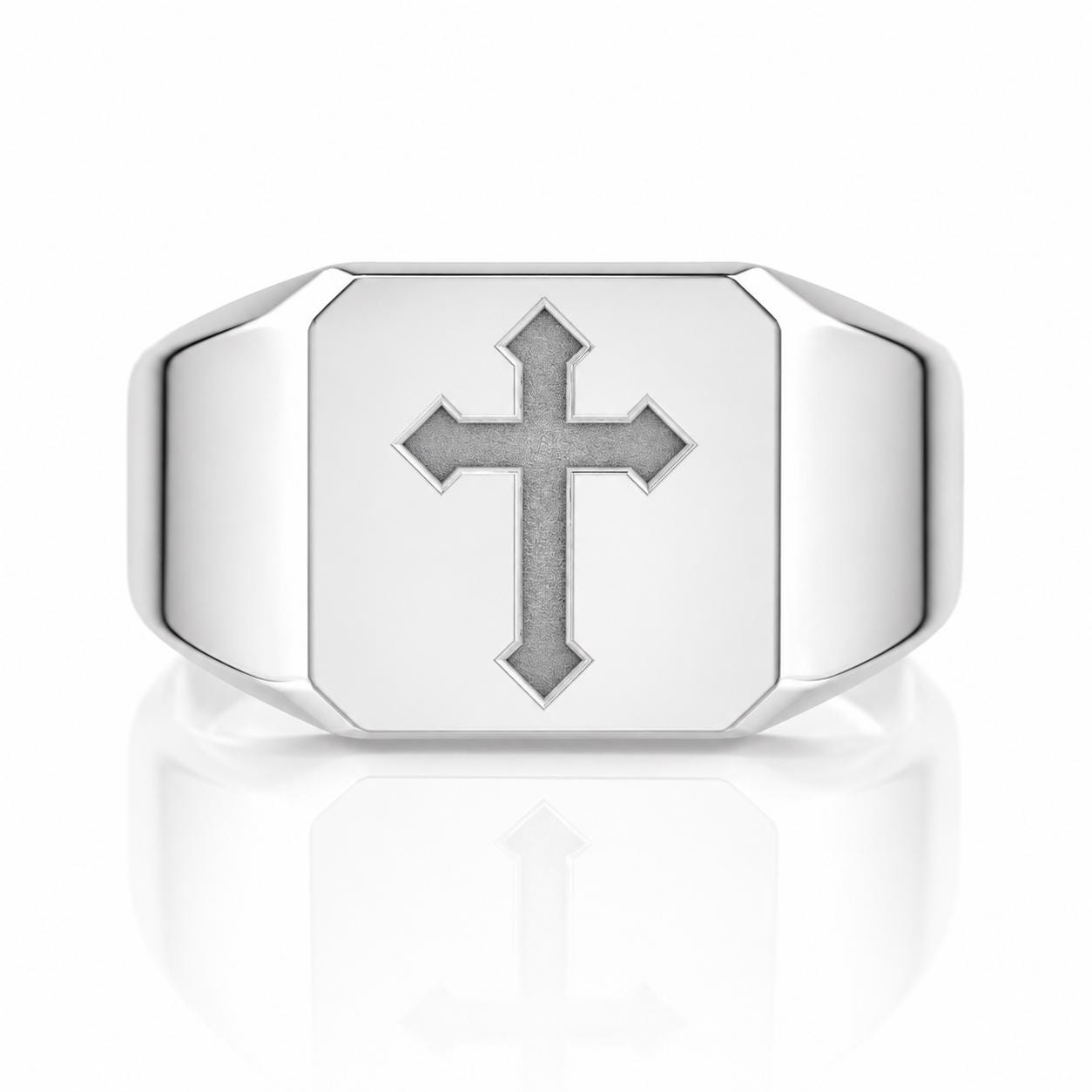A silver ring with a large cross symbol on it.