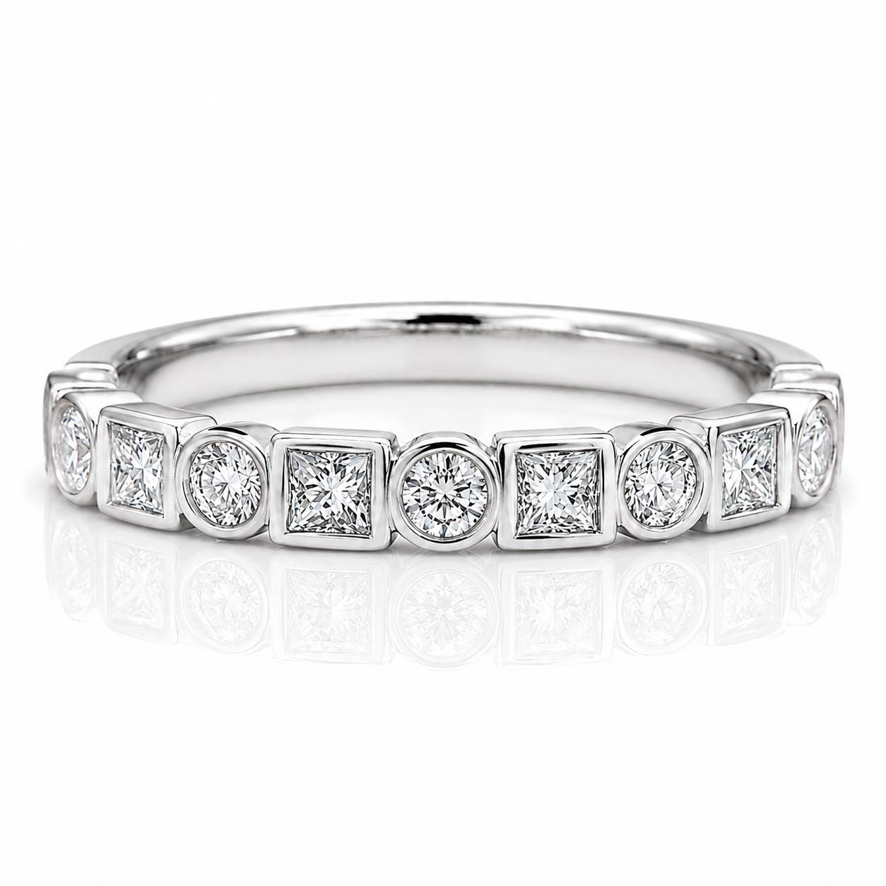 A silver ring with a row of diamonds set in a geometric pattern.