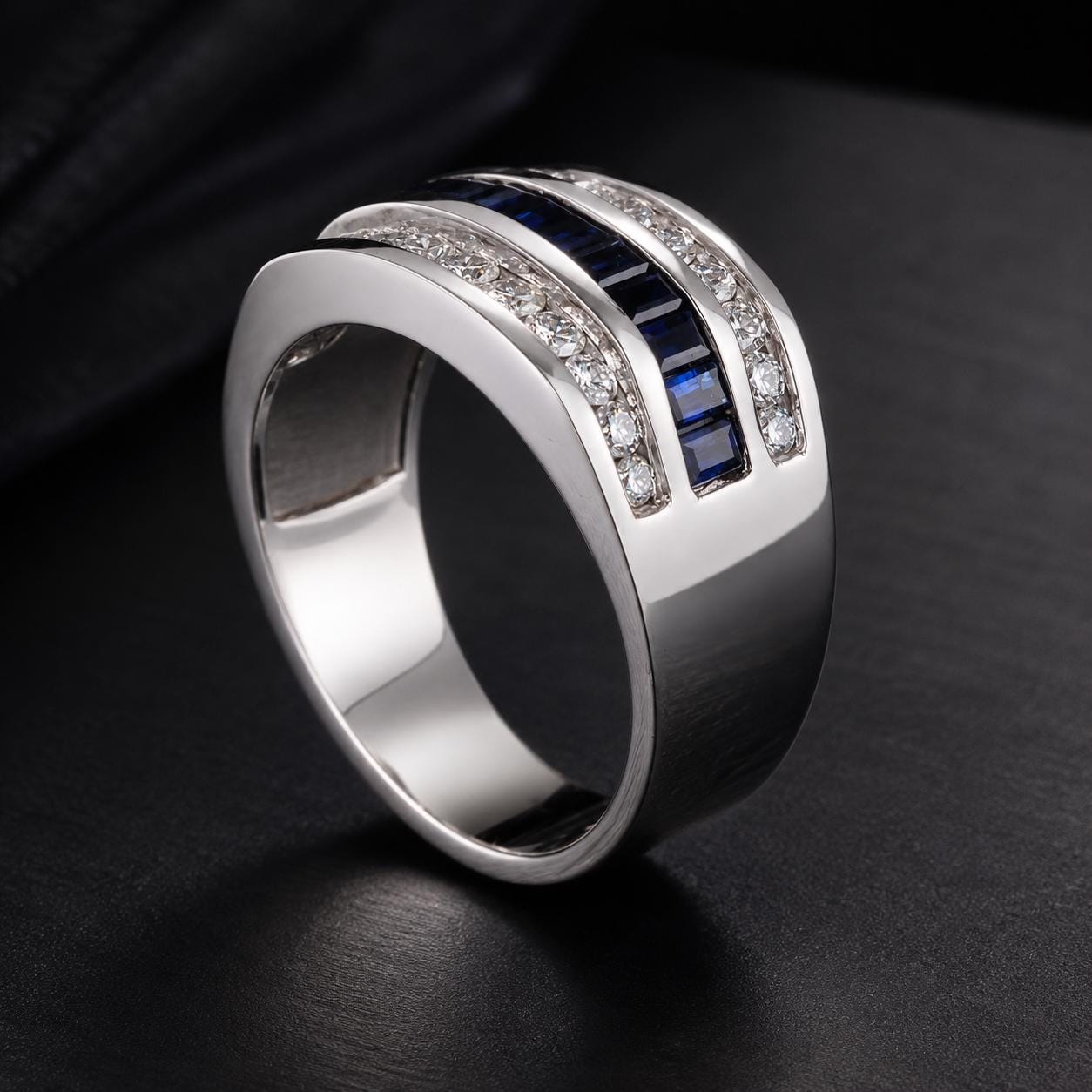 A silver ring with a unique design, featuring a row of blue sapphires set in a diamond pattern.