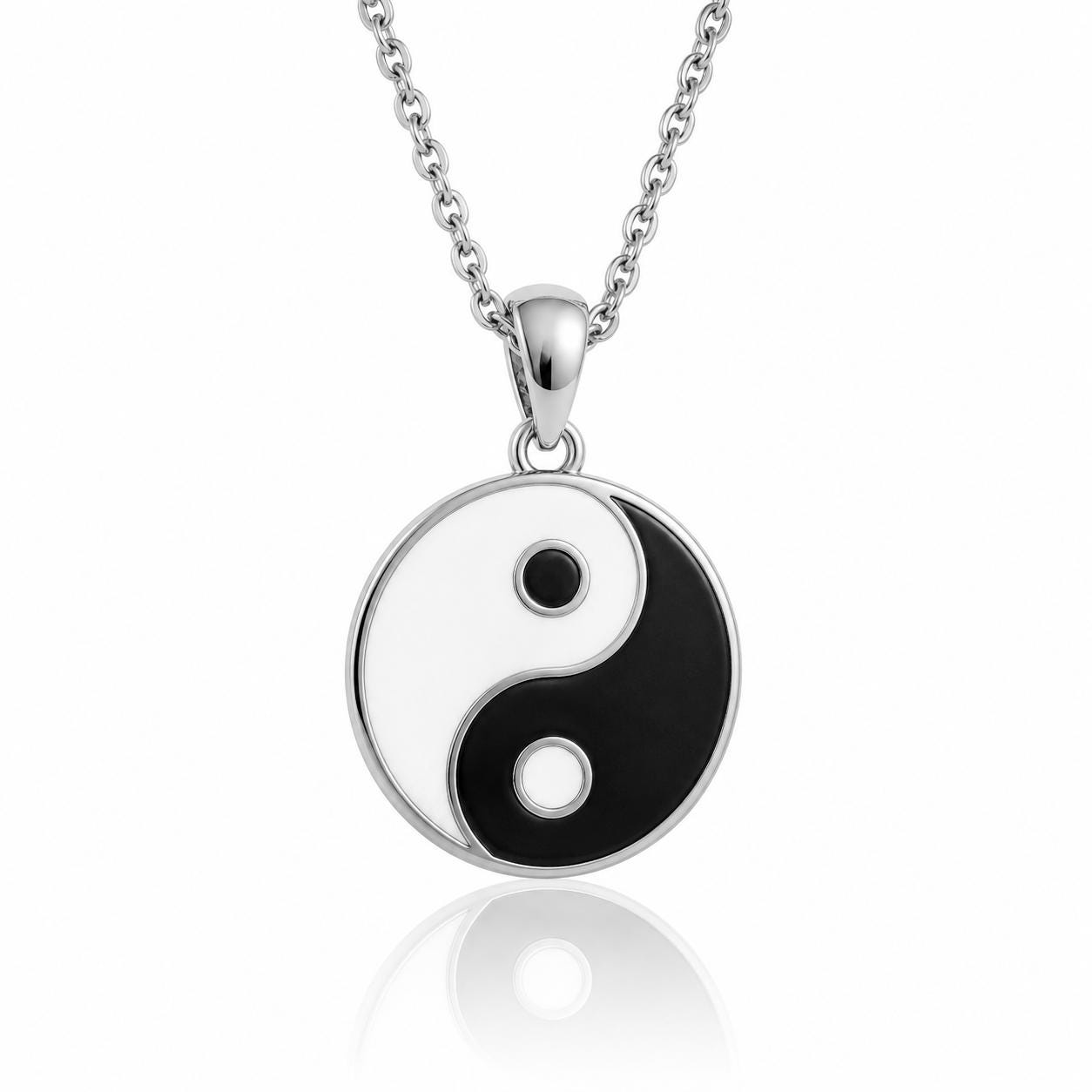 A silver-toned necklace with a circular pendant featuring a yin and yang symbol, which is a traditional symbol of balance and harmony.