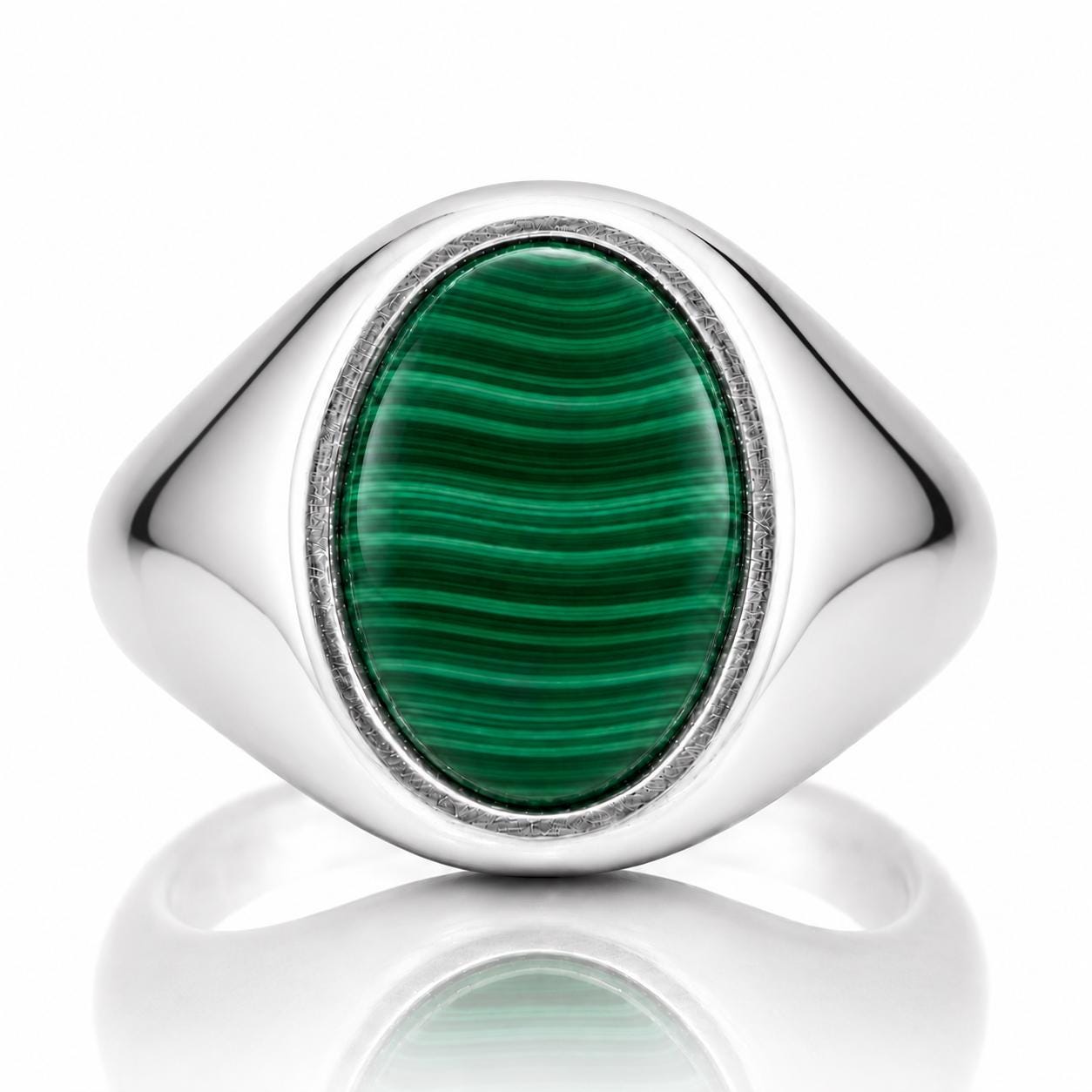 A silver ring with a large oval-shaped green gemstone in the center.