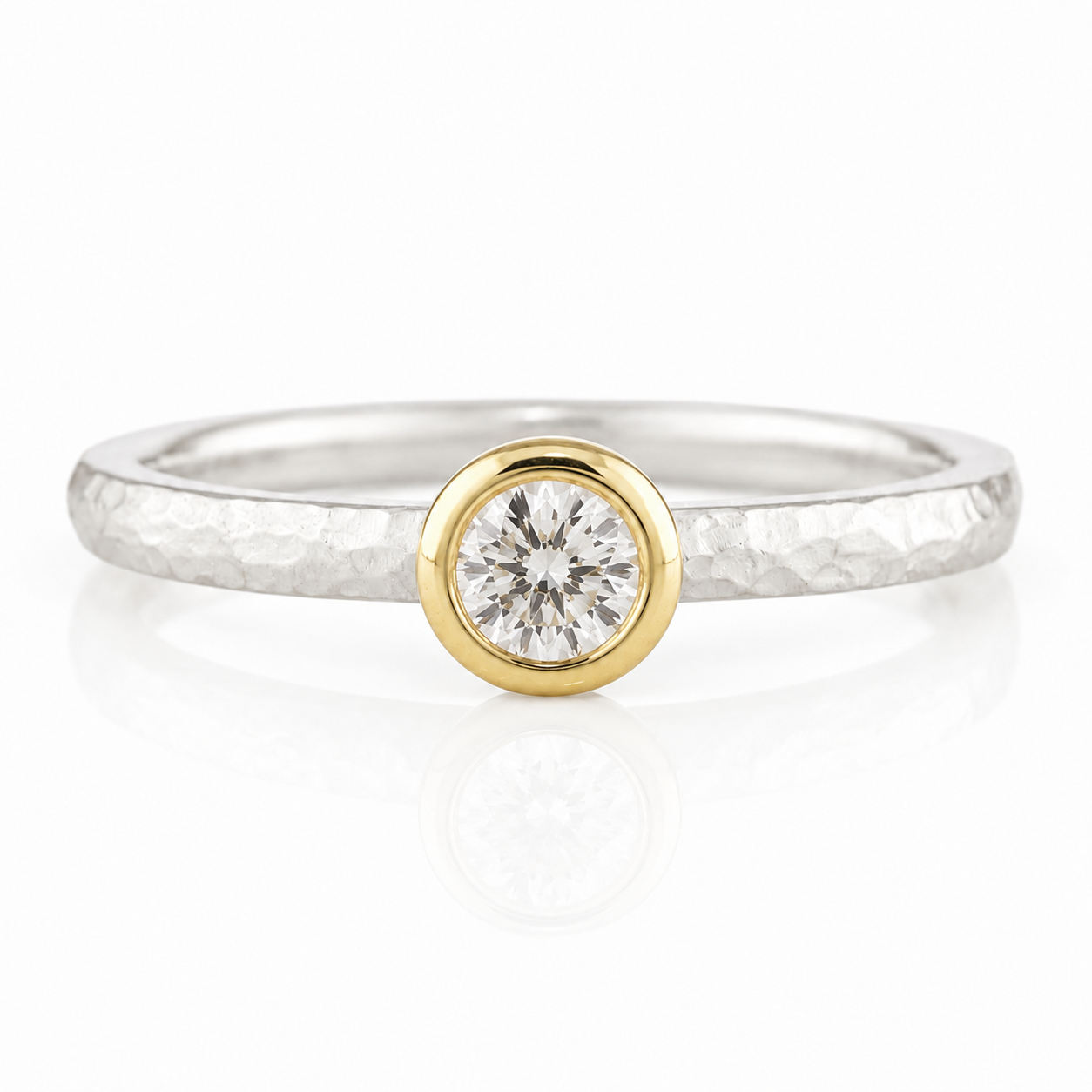 A silver ring with a large, round diamond set in the center.