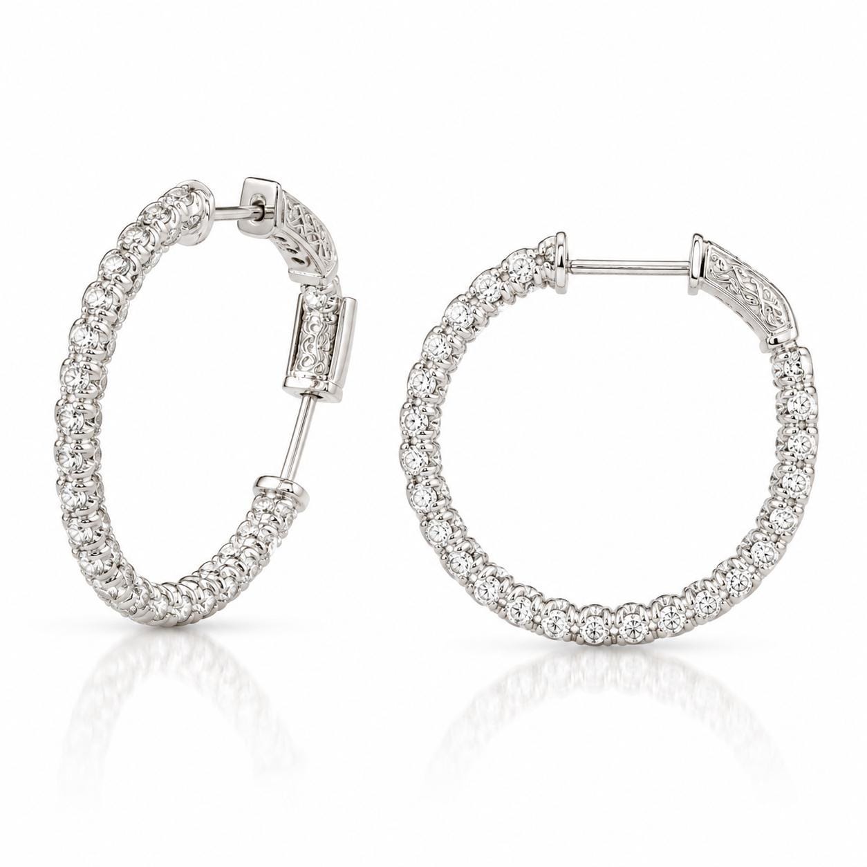 A pair of elegant silver earrings with a row of small diamonds set in the center.