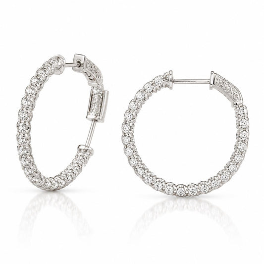 A pair of elegant silver earrings with a row of small diamonds set in the center.