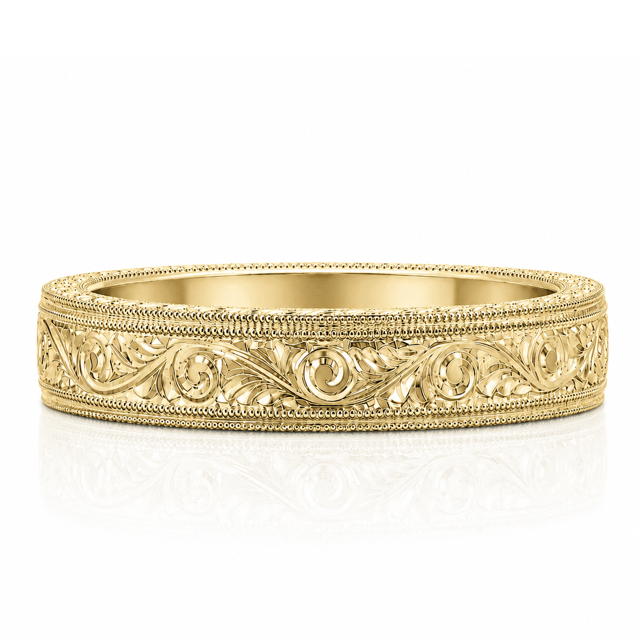 A gold-colored ornate ring with intricate floral designs along the band.