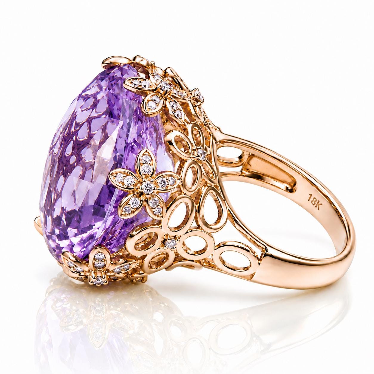A large, ornate gold ring with a large purple gemstone and intricate floral designs.