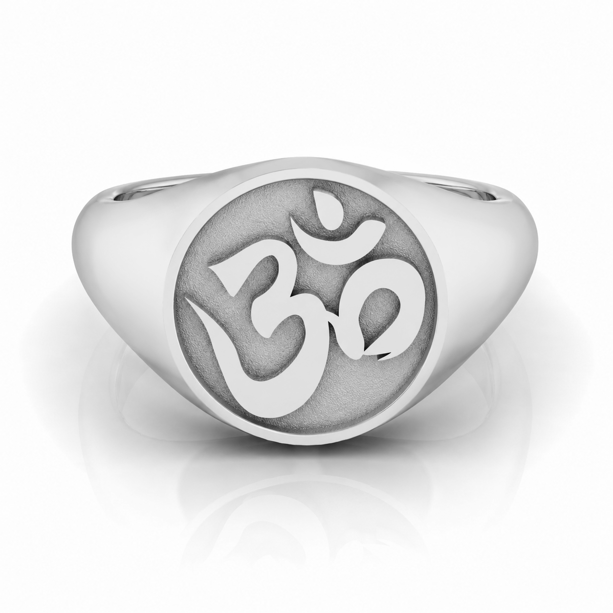 A silver ring with a circular design featuring the Om symbol, which is a significant symbol in Hinduism and yoga.