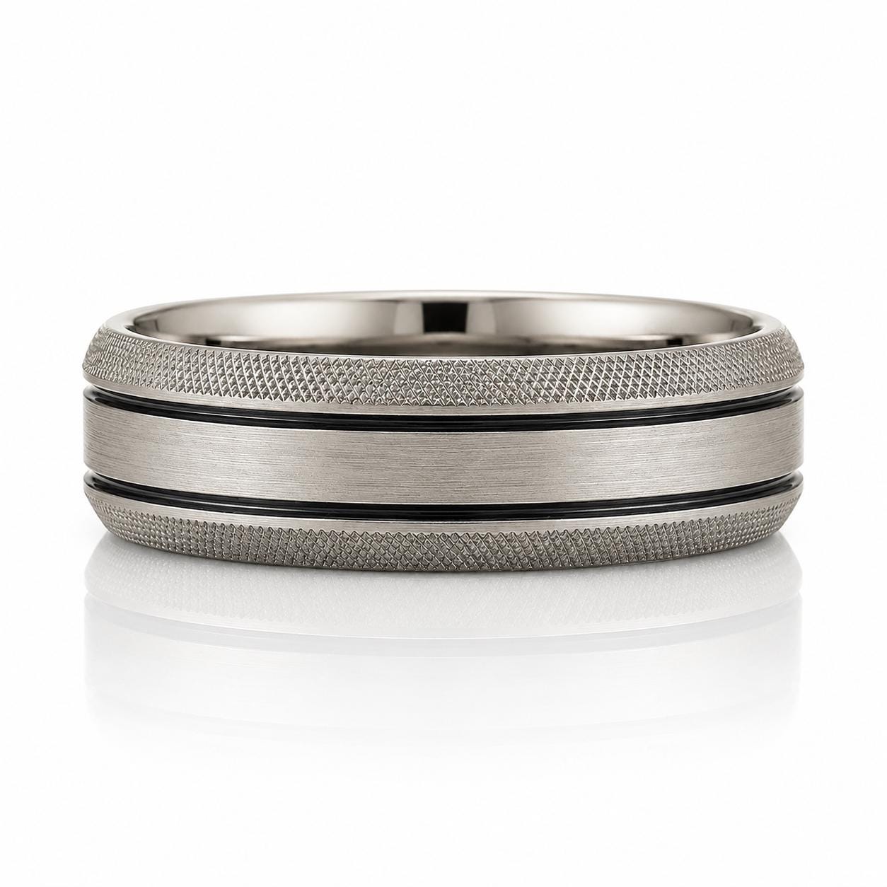 A silver ring with a textured band and a black stripe running through it.
