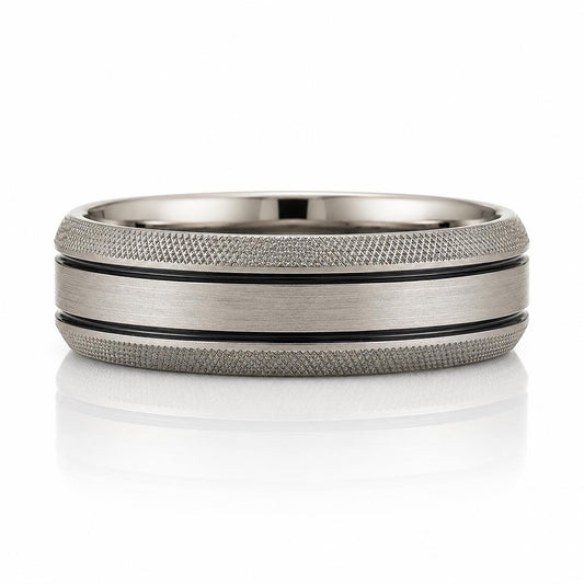 A silver ring with a textured band and a black stripe running through it.