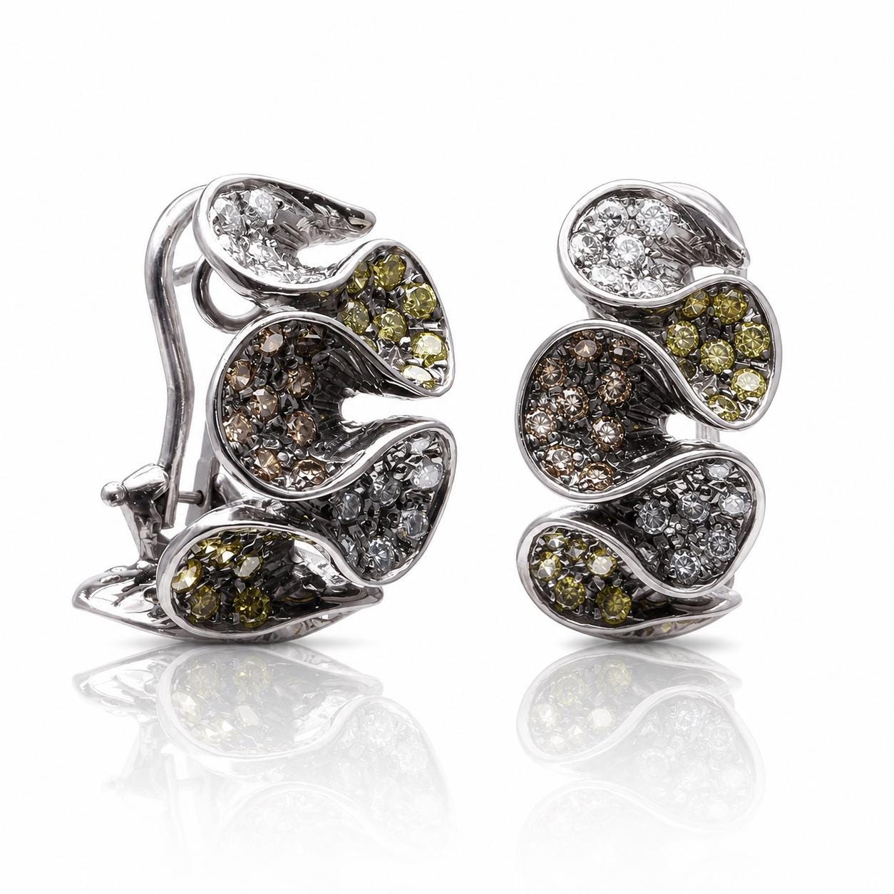 a pair of earrings with a unique, intricate design. The earrings are made of silver and are adorned with various colored gemstones, including diamonds and other precious stones. The earrings are displayed against a white background, which highlights their elegant design and sparkling appearance.