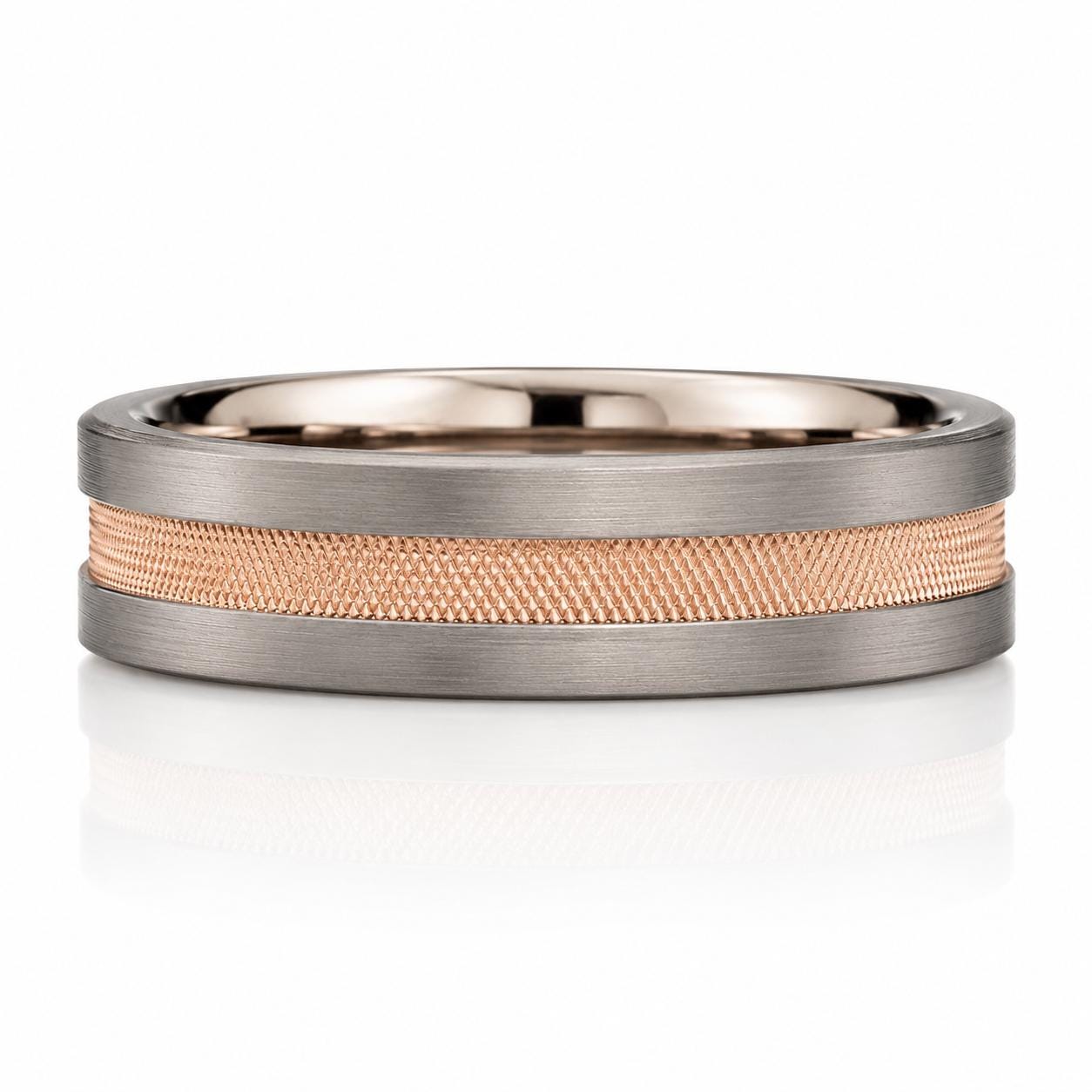 A silver ring with a textured band made of small, interlocking metal pieces.