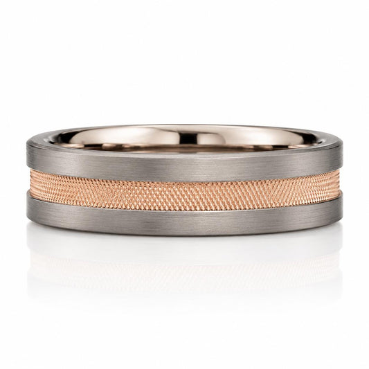 A silver ring with a textured band made of small, interlocking metal pieces.