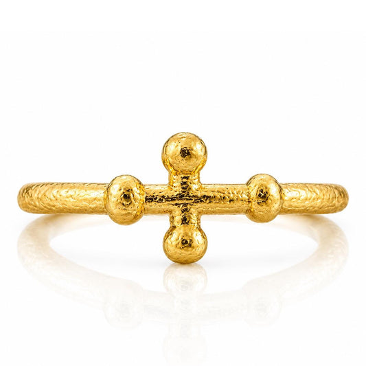 A gold ring with a unique design featuring three small balls arranged in a cross shape.
