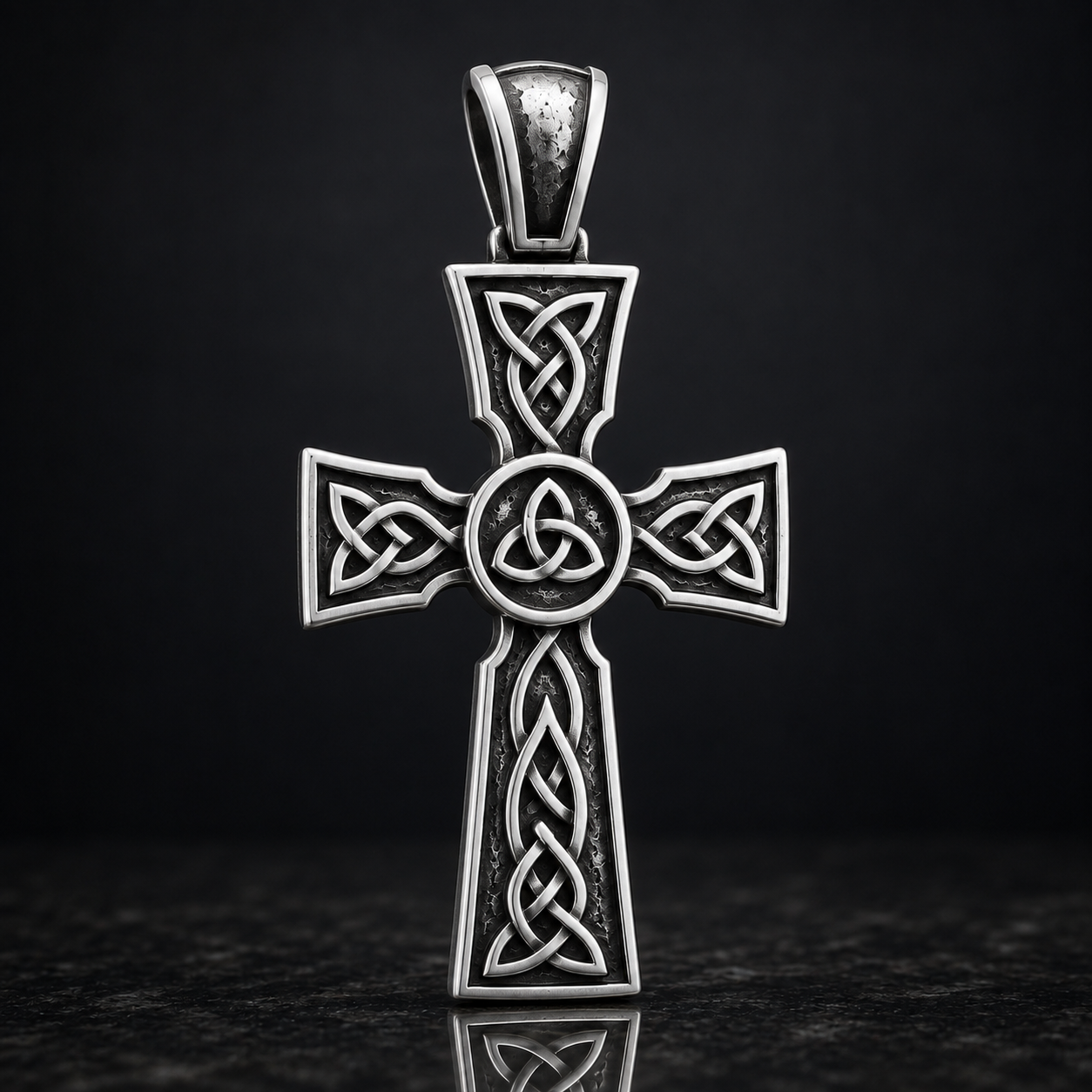 A silver-colored Celtic cross pendant with intricate knot designs and a central circle.