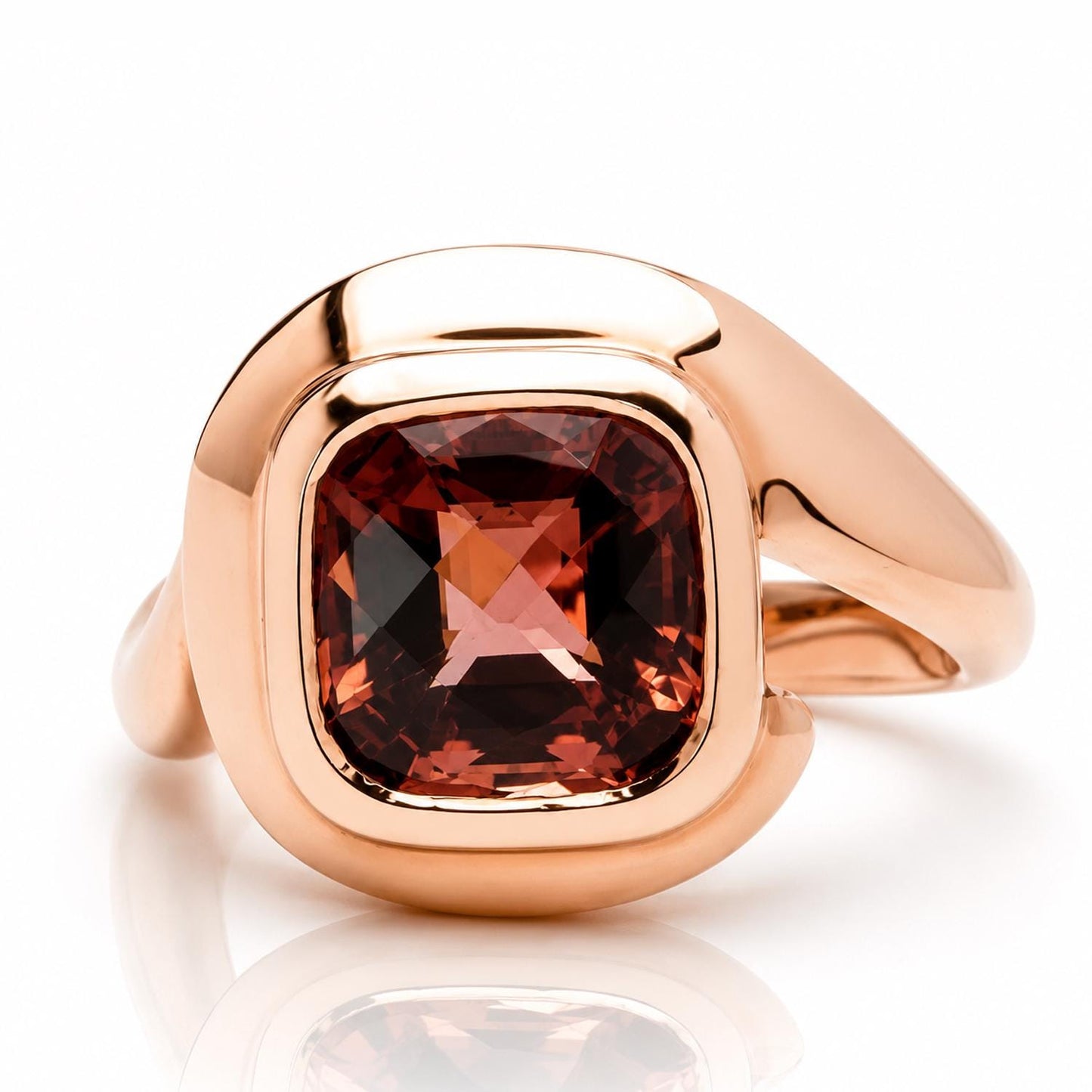 A gold ring with a large, square-cut gemstone set in the center.