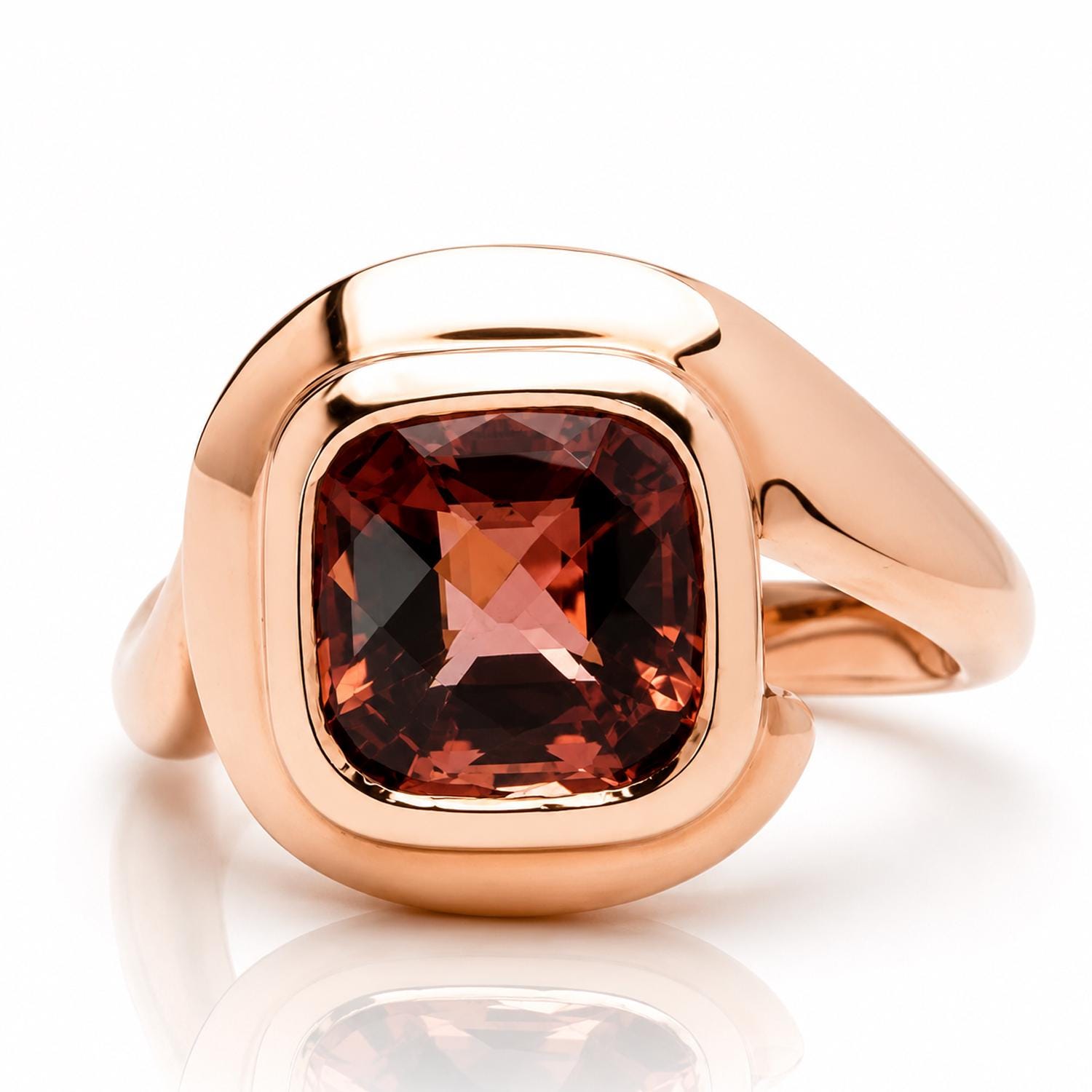 A gold ring with a large, square-cut gemstone set in the center.