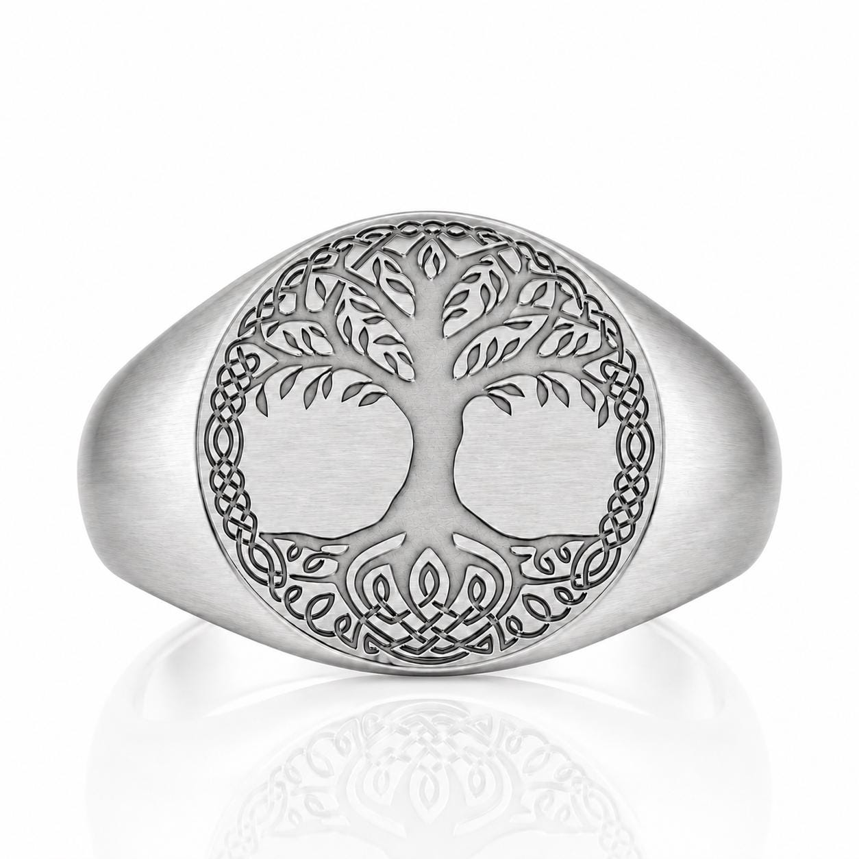 A silver ring with a tree design in the center, surrounded by intricate Celtic knot patterns.