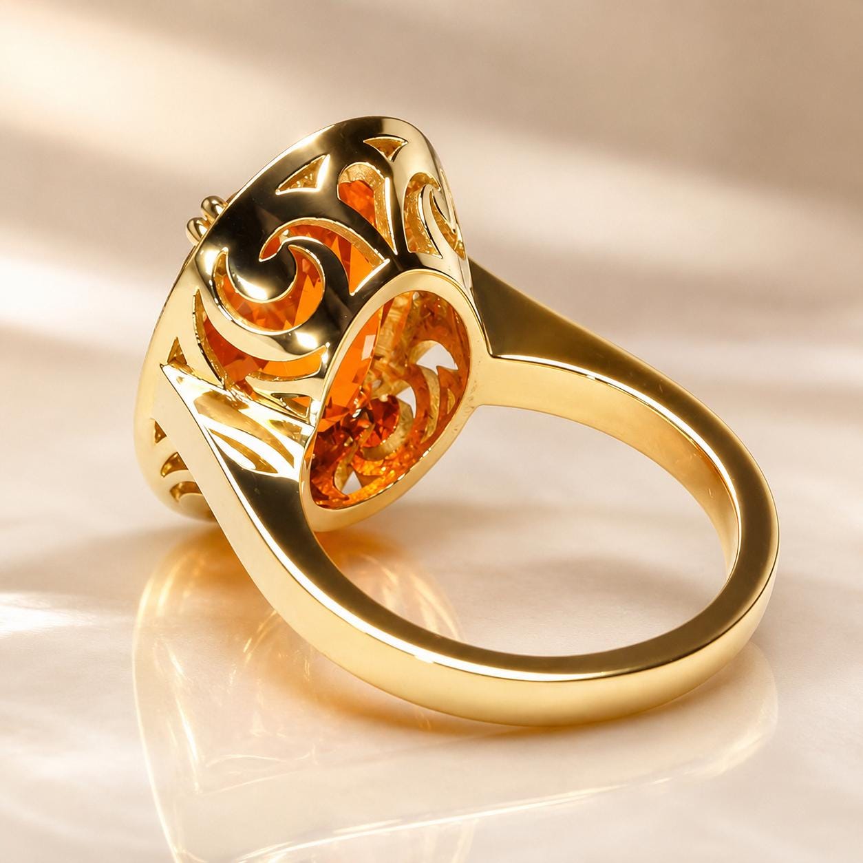 A gold ring with a large, round gemstone set in the center, surrounded by intricate, swirling designs.