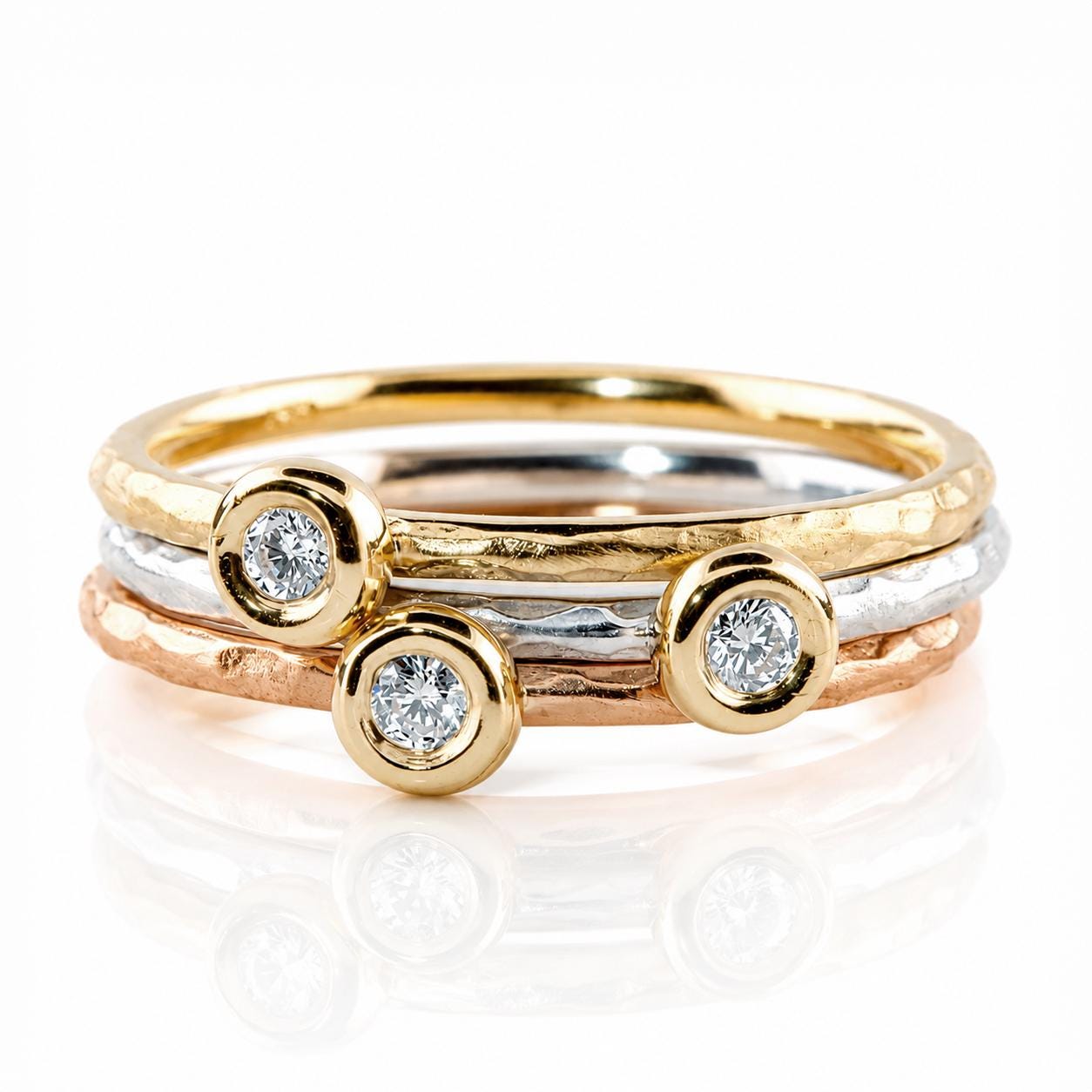 A ring with three round diamonds set in gold and silver bands.