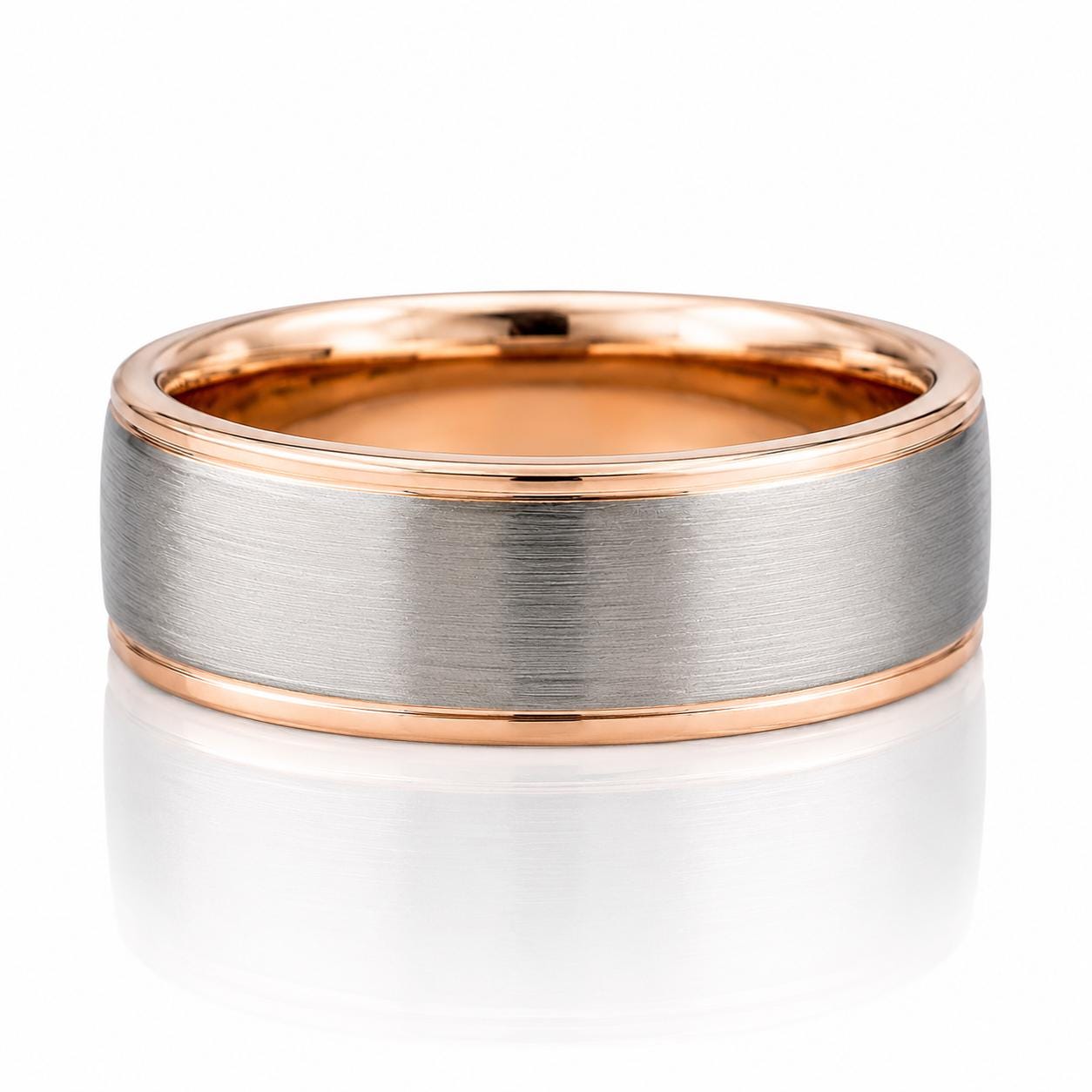 A silver-toned ring with a thin gold band, showcasing its intricate design and elegant appearance.