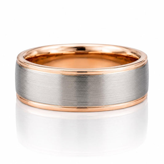 A silver-toned ring with a thin gold band, showcasing its intricate design and elegant appearance.
