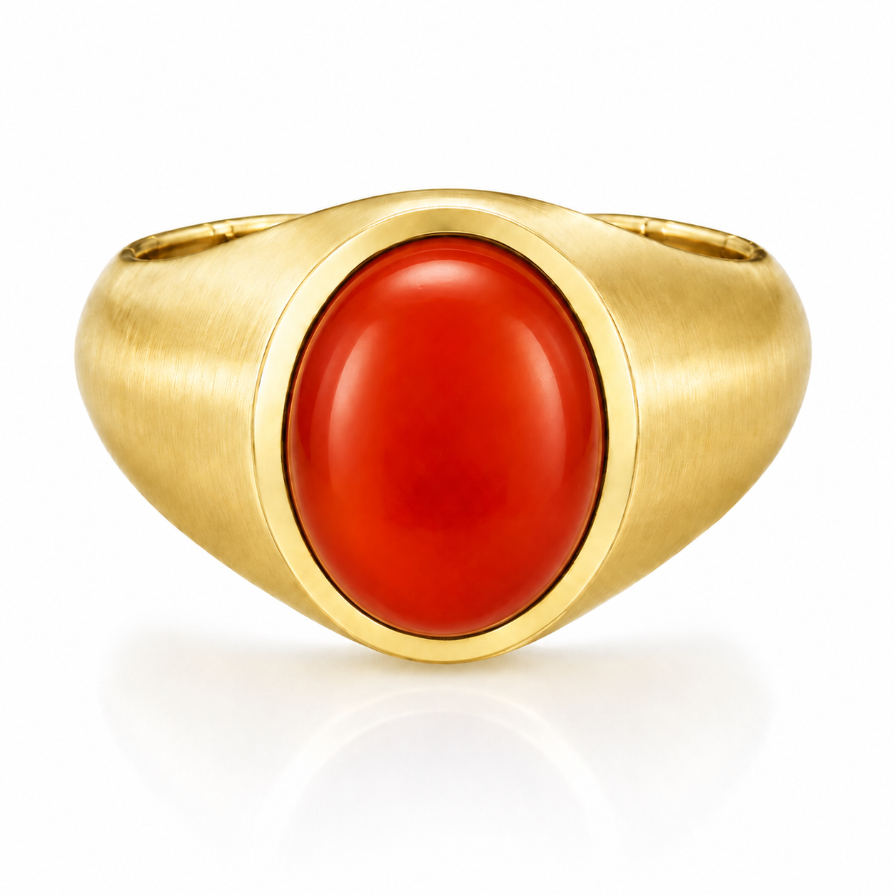 A gold ring with a large, bright red gemstone in the center.