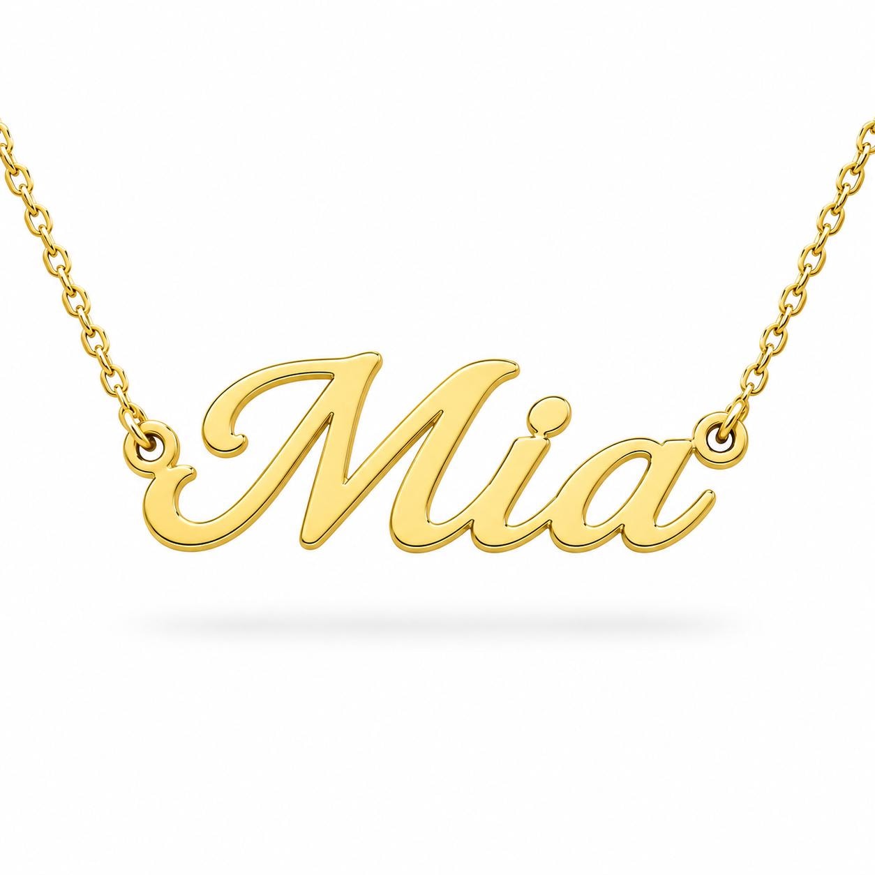 A gold necklace with the name "Mia" engraved on it.