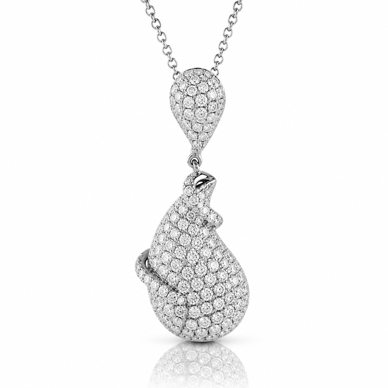 A silver necklace with a pendant featuring a large, sparkling diamond design.