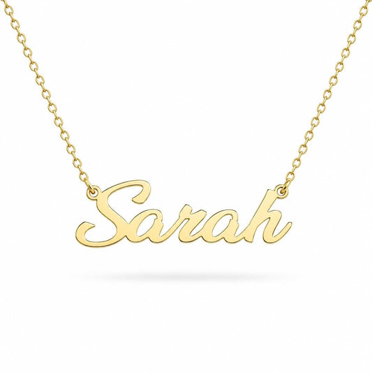 A gold-colored necklace with the name "Sara" engraved on it.