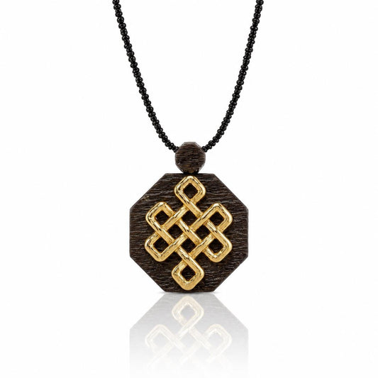 A necklace with a wooden pendant featuring a golden knot design.