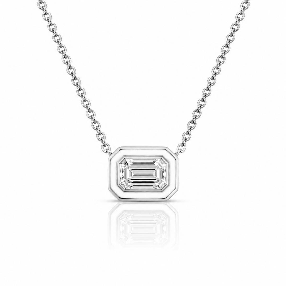 A silver necklace with a large, clear gemstone pendant in the center.