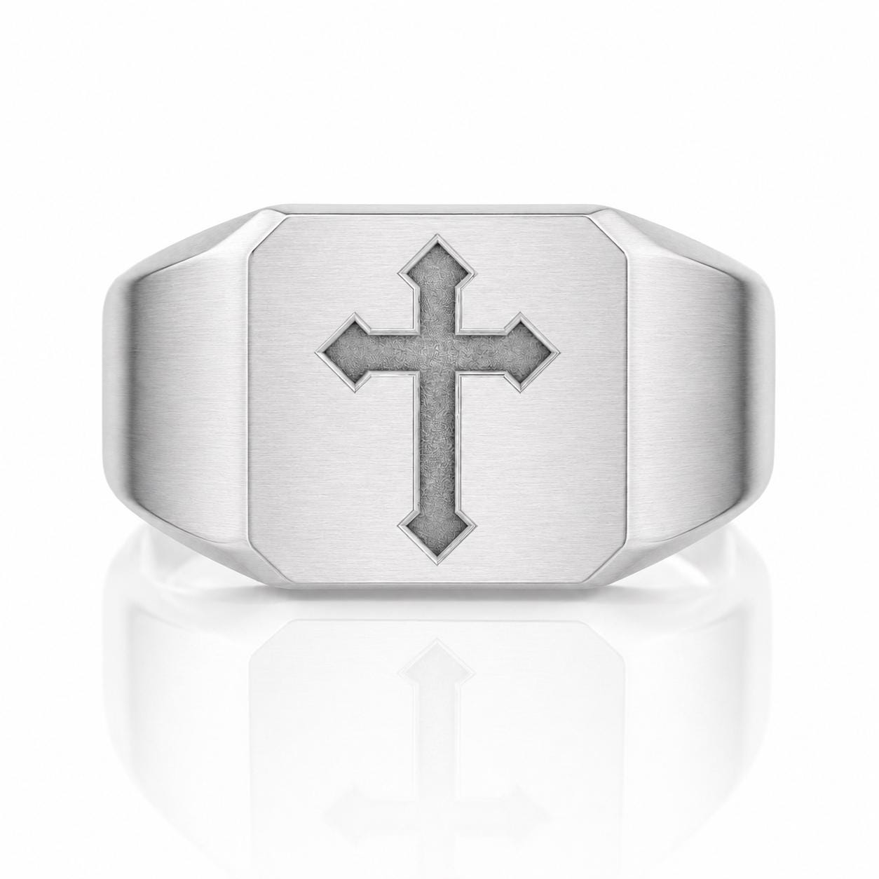 A silver ring with a large cross symbol on it.
