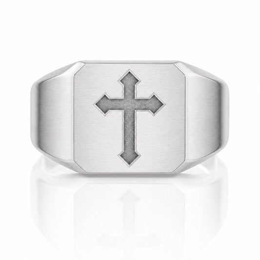 A silver ring with a large cross symbol on it.