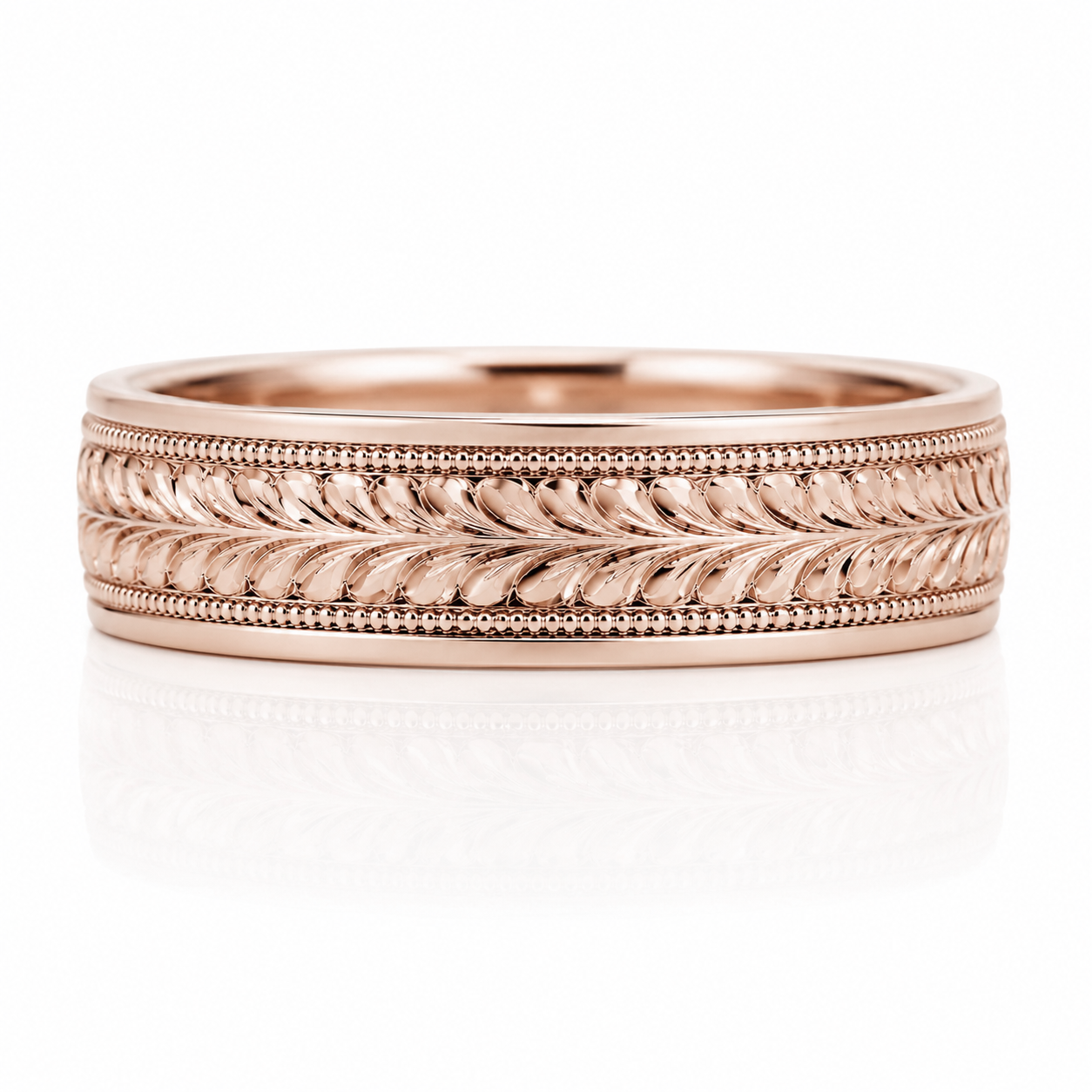 A rose gold ring with an intricate engraved design featuring a repeating pattern of leaves or flowers.