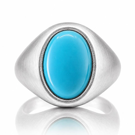A silver ring with a large, bright blue oval-shaped stone in the center.