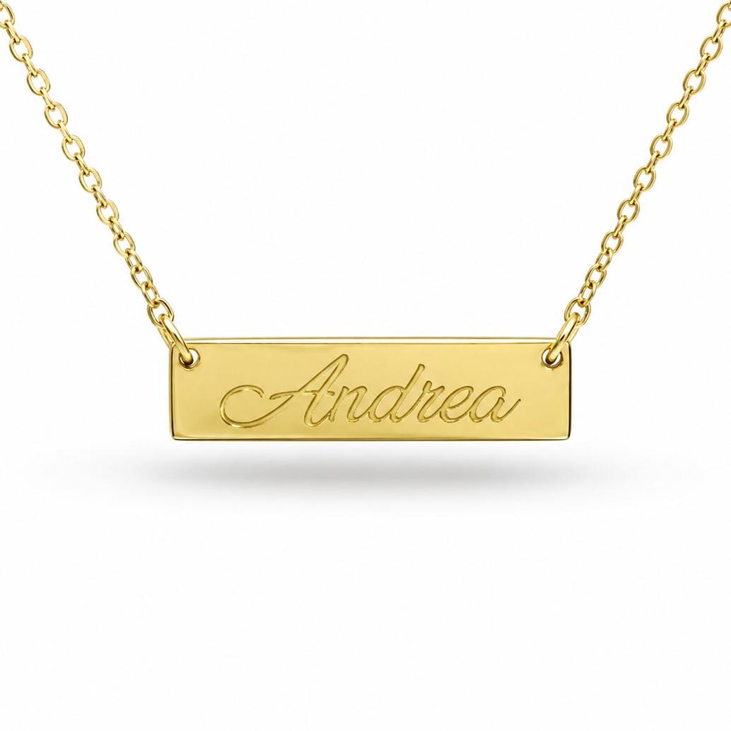 A gold-colored necklace with a rectangular pendant engraved with the name "Andrea".