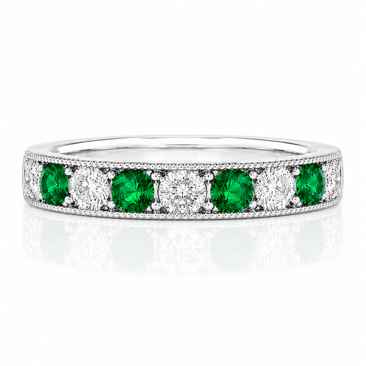 A silver band ring with a row of green and white diamonds set in it.