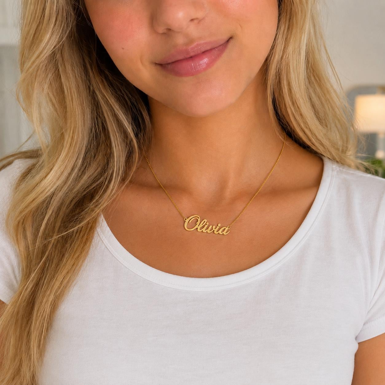 A woman wearing a gold necklace with the name "Olivia" engraved on it.