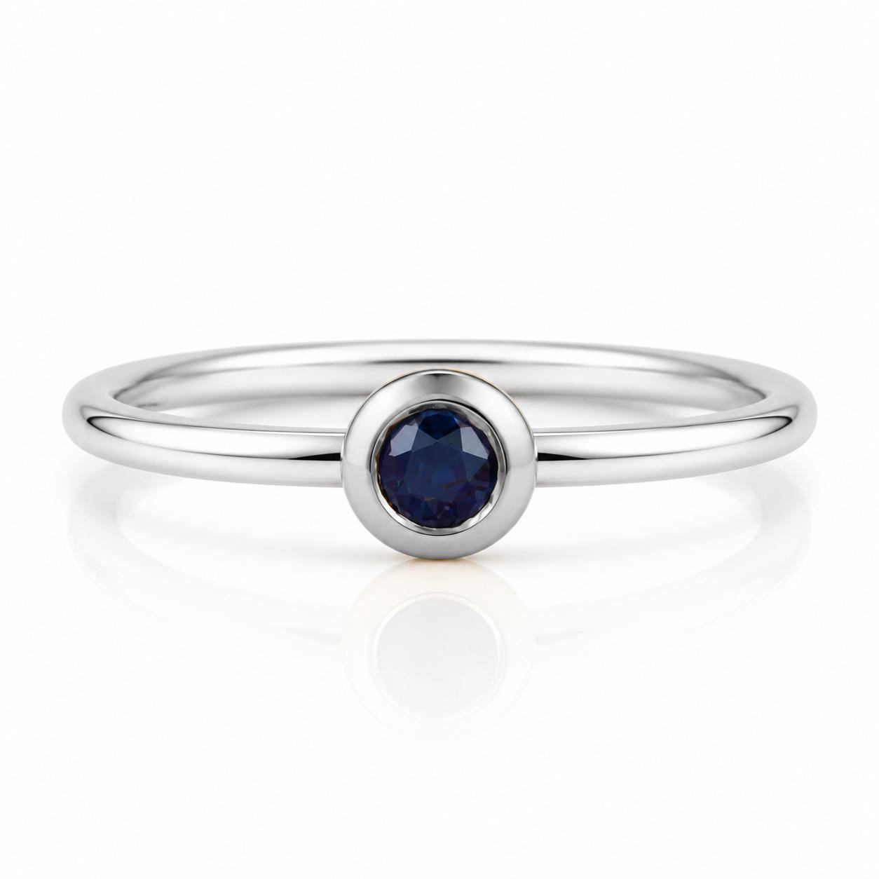 A silver ring with a blue gemstone in the center.