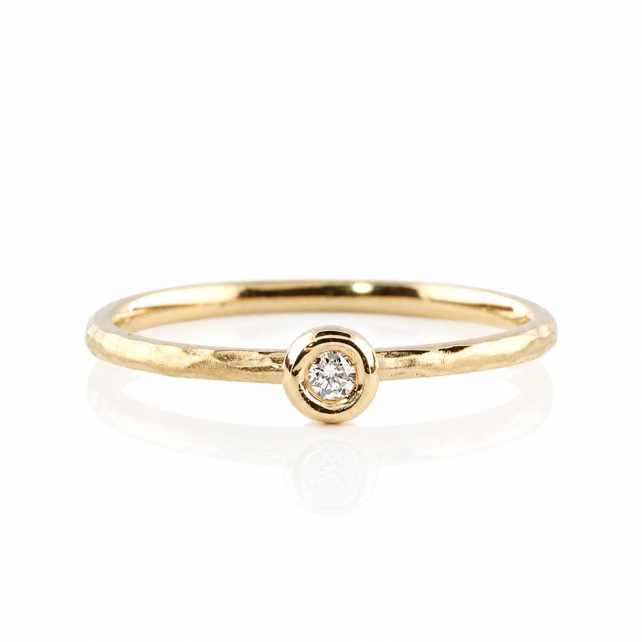 A simple gold ring with a small diamond set in the center.